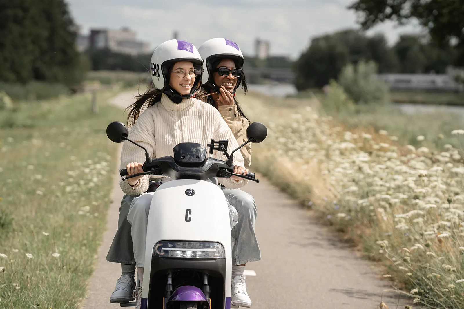 Two people on Check scooter